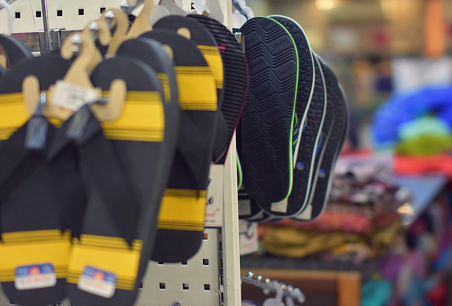 Flip-flops displayed on metal racks in a retail store.
